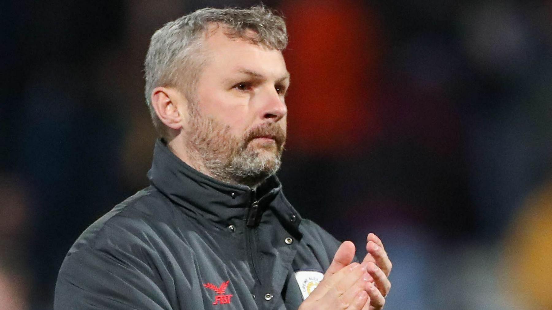 Kenny Lunt claps the crowd after a Crewe game