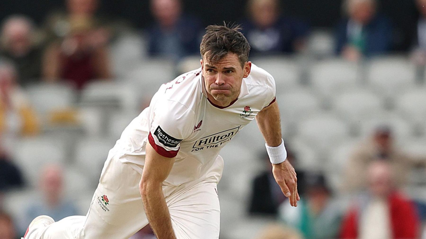 Jimmy Anderson bowling for Lancashire at Old Trafford against Middlesex, having completed his delivery and in his follow-through