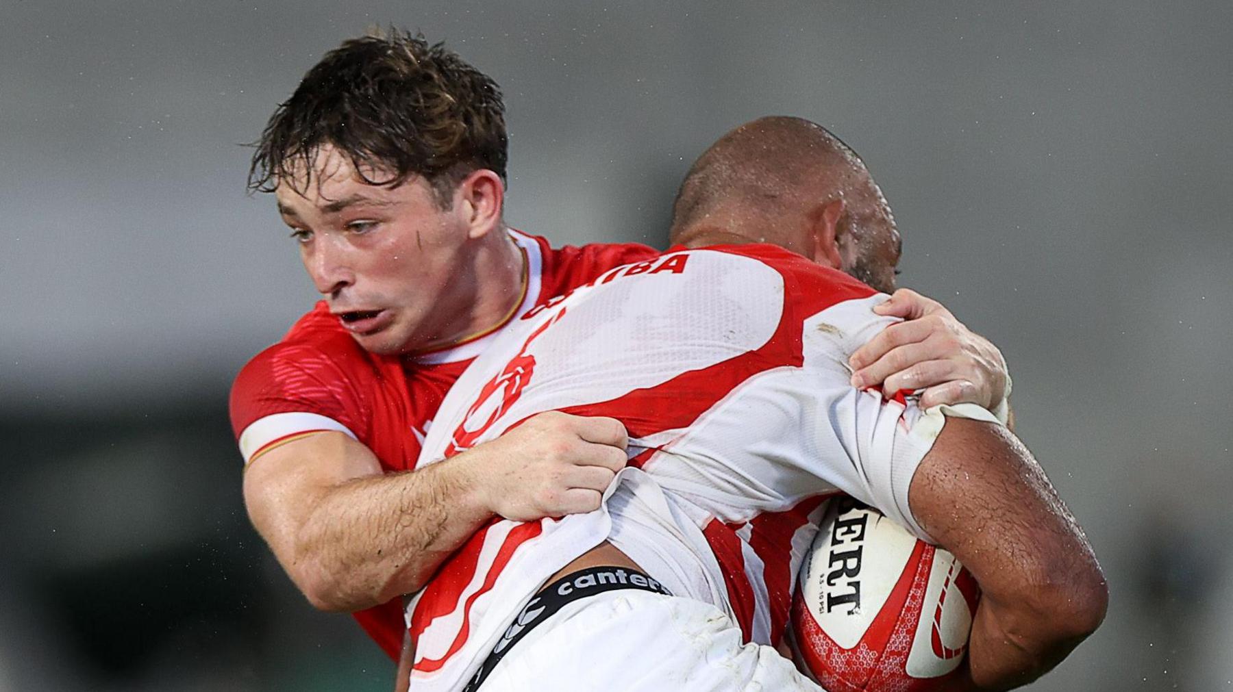 Dan Edwards tackles a Japan attacker