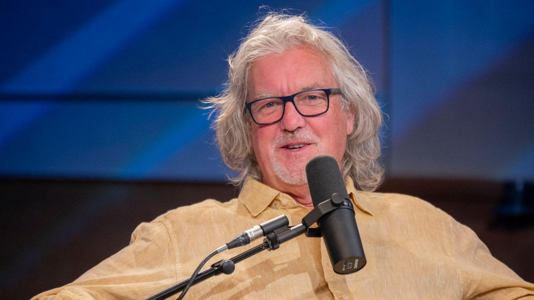 James May sitting in front of a microphone