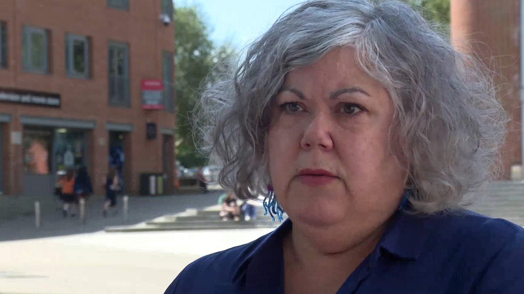 Maxine Webb is standing outside on a sunny day. She's wearing a dark blue shirt.