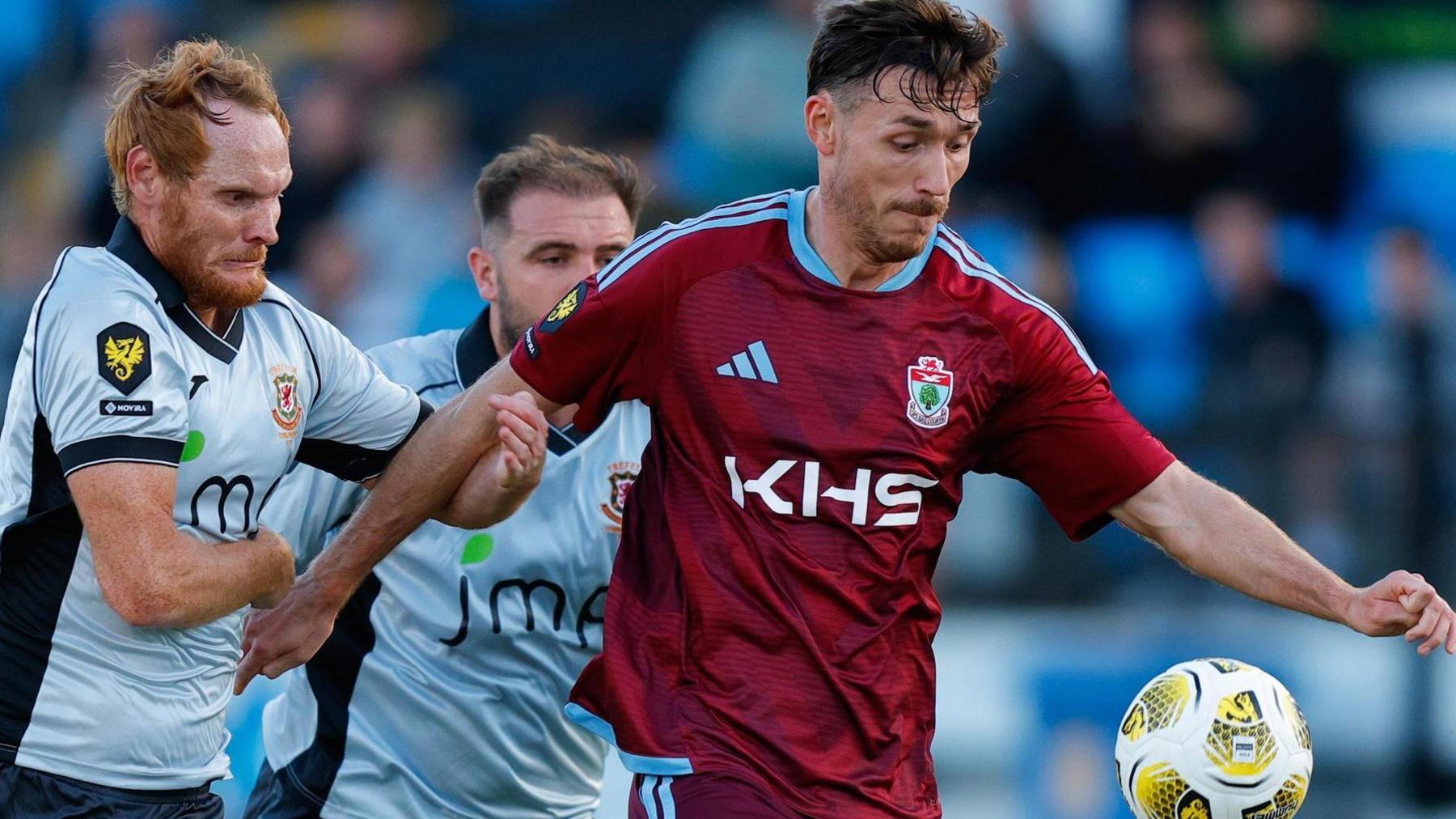 Adam Davies (right) battles for the ball with Trefelin's former Wales and Swansea City player Shaun MacDonald