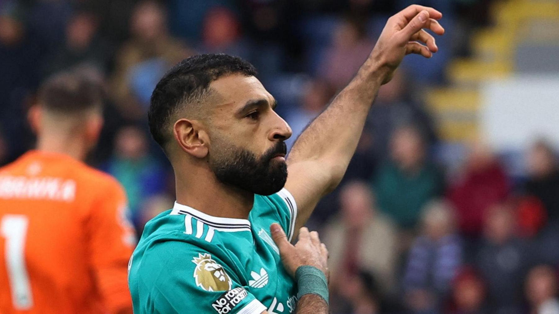 Mohamed Salah celebrates after scoring the stoppage-time penalty that gave Liverpool victory at Burnley