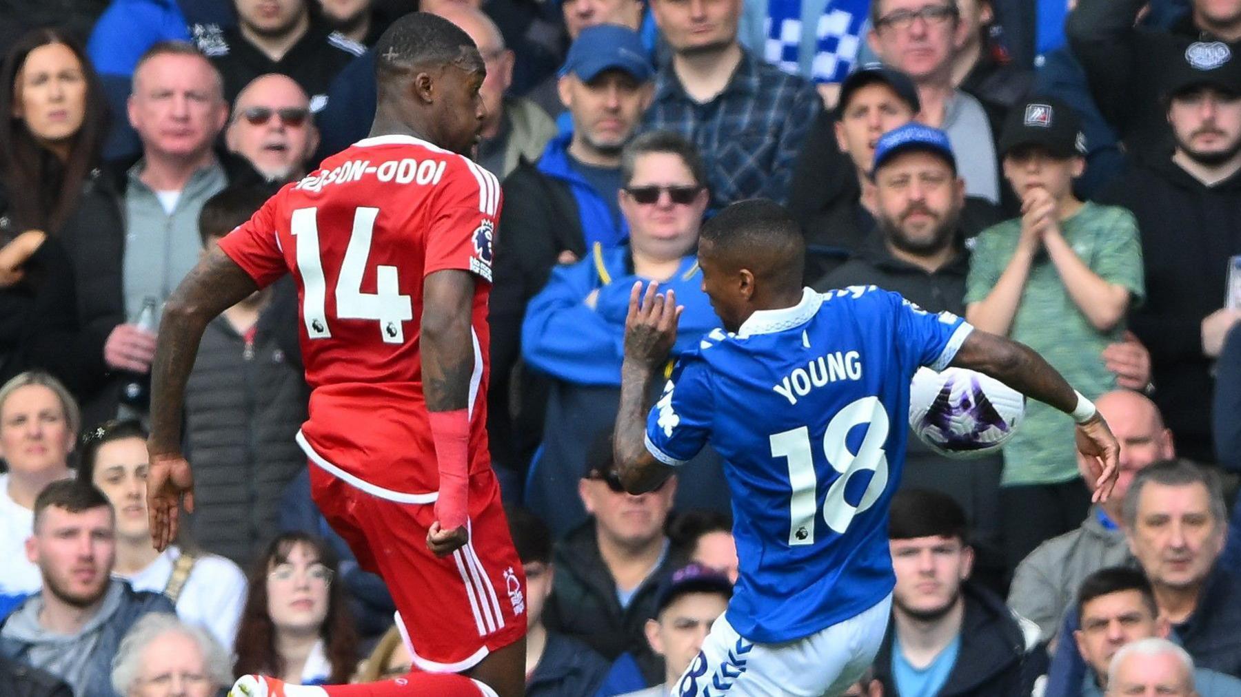 The ball strikes Ashley Young's outstretched right arm following a cross from Callum Hudson-Odoi, who is jumping next to him.