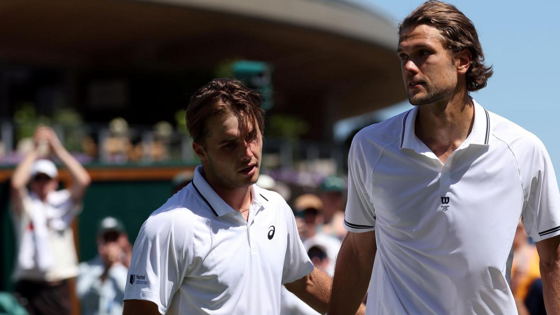 Arthur Fery is congratulated by Otto Virtanen after their Wimbledon second-round match