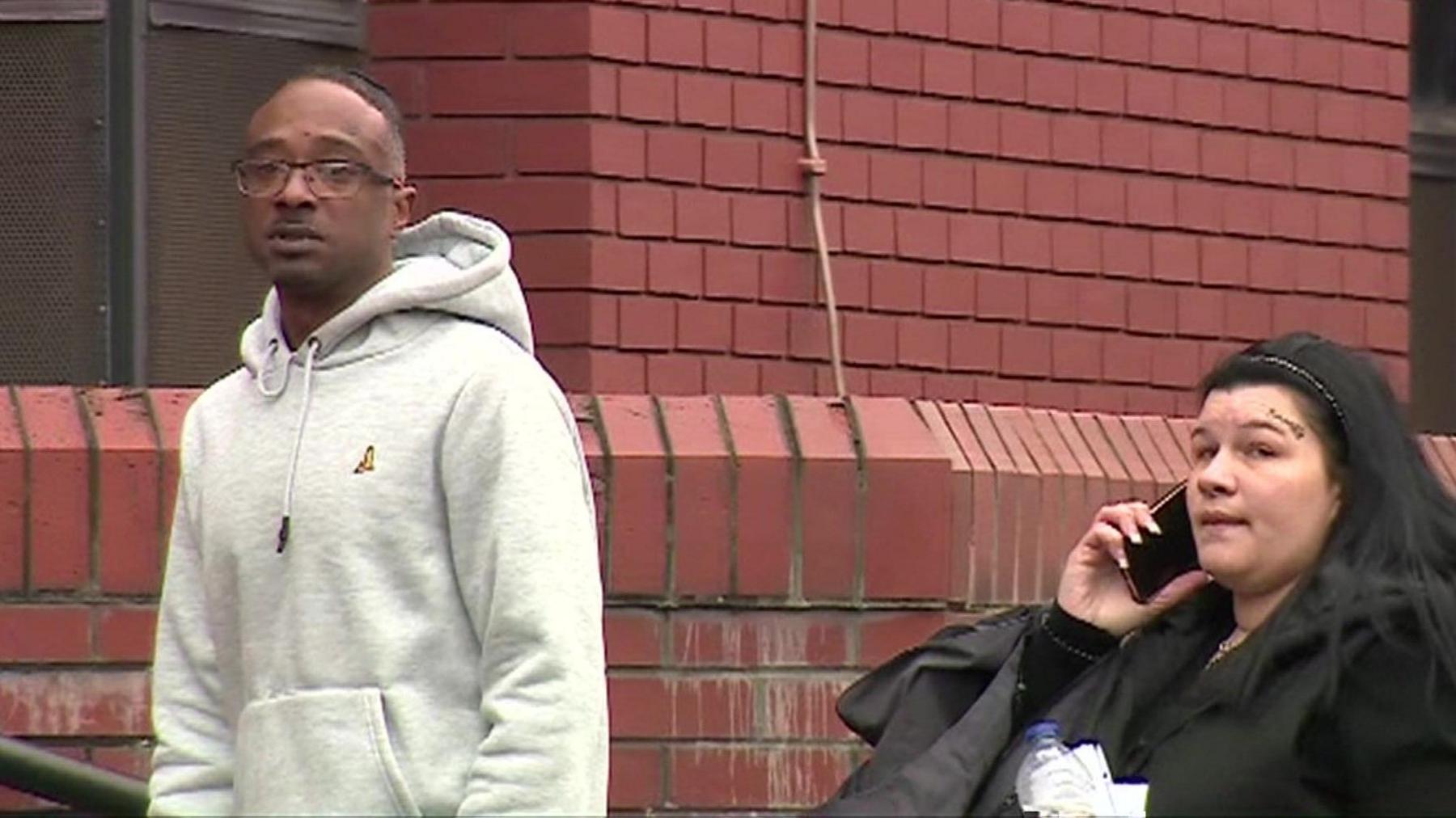 Two people on the steps of Leicester Crown Court