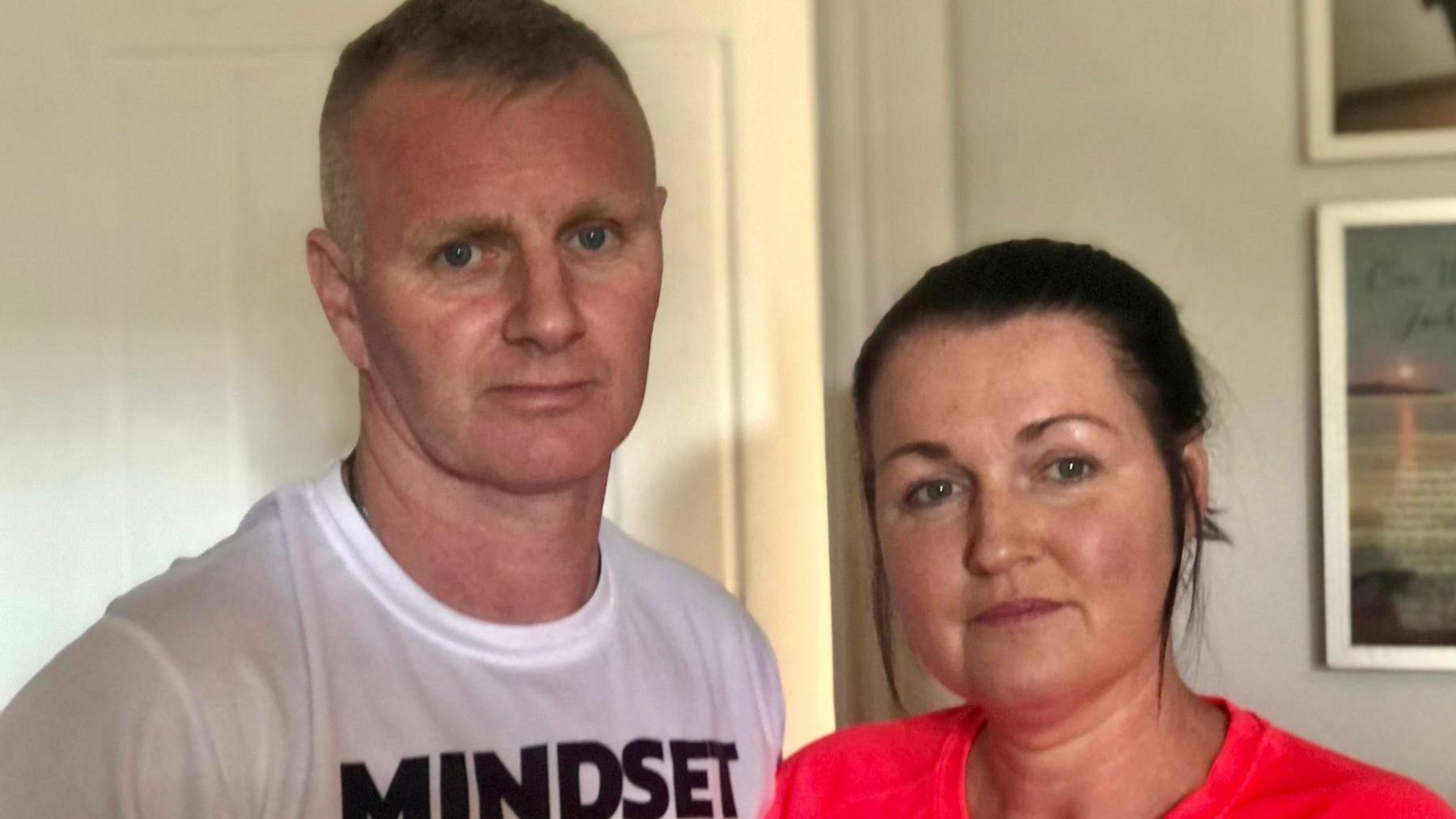 Tony and Sabrina Edgar standing side by side at their home