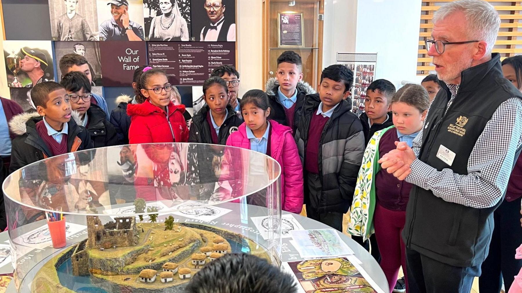 Education officer, Peter Land, describing the history of the Hill of O'Neill to pupils from St Patrick's Primary School