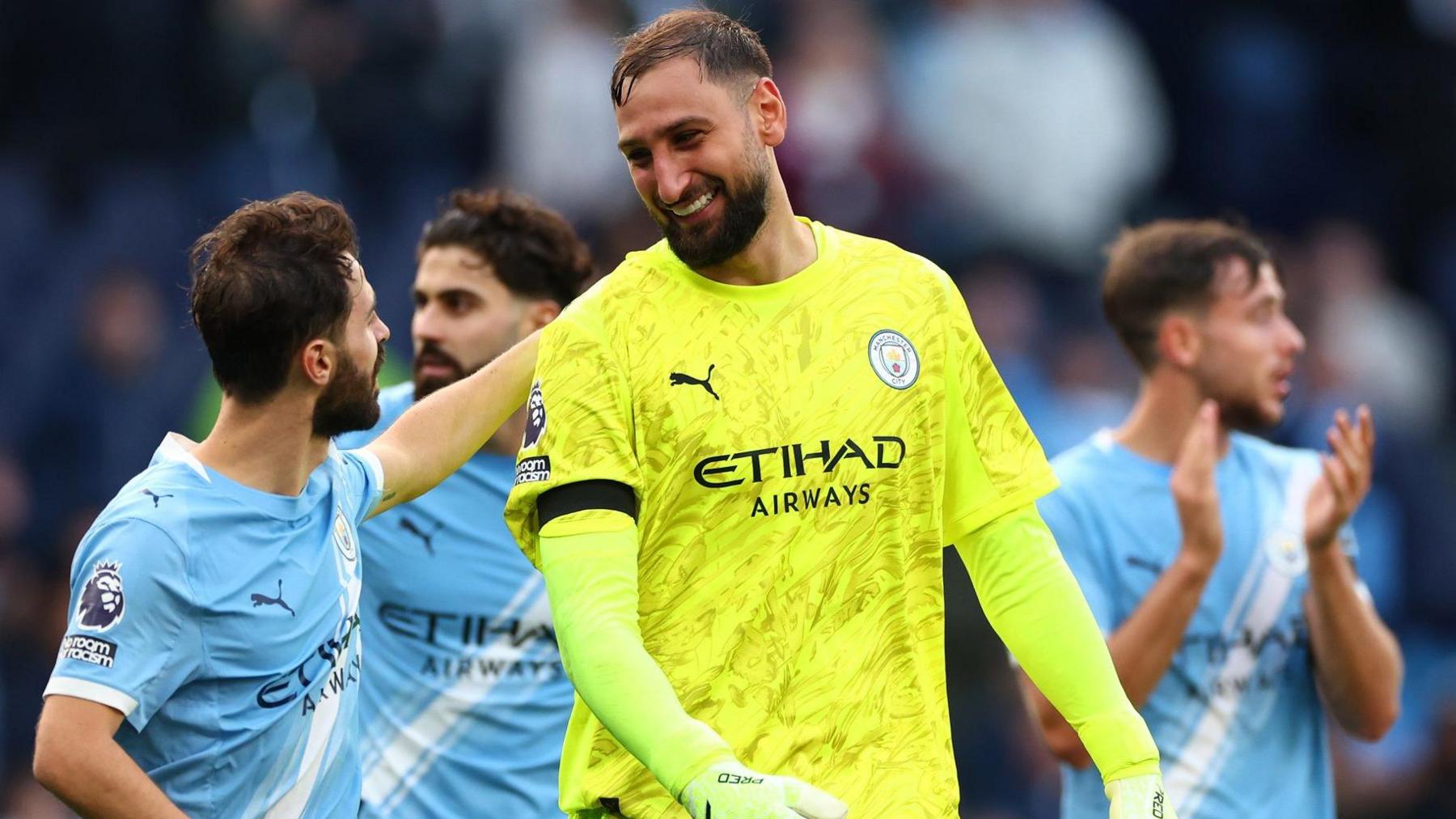 Gianluigi Donnarumma celebrates with his Manchester City team-mates after the win over Manchester United