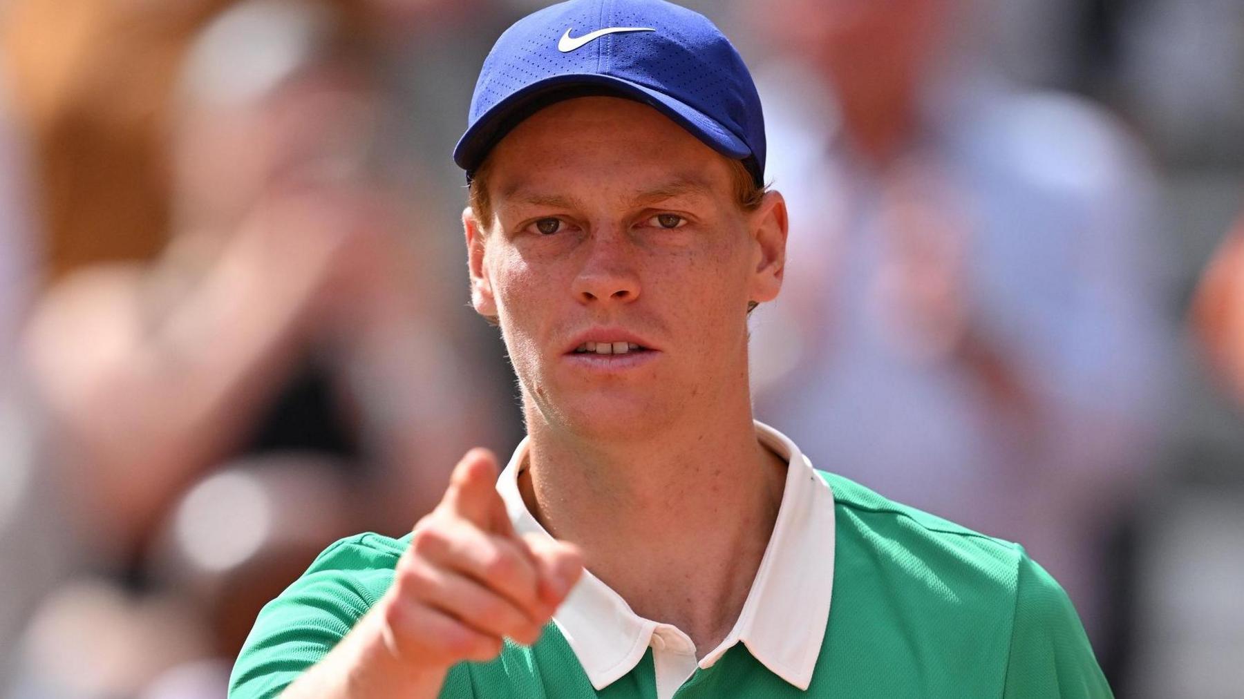 Jannik Sinner points towards the camera 