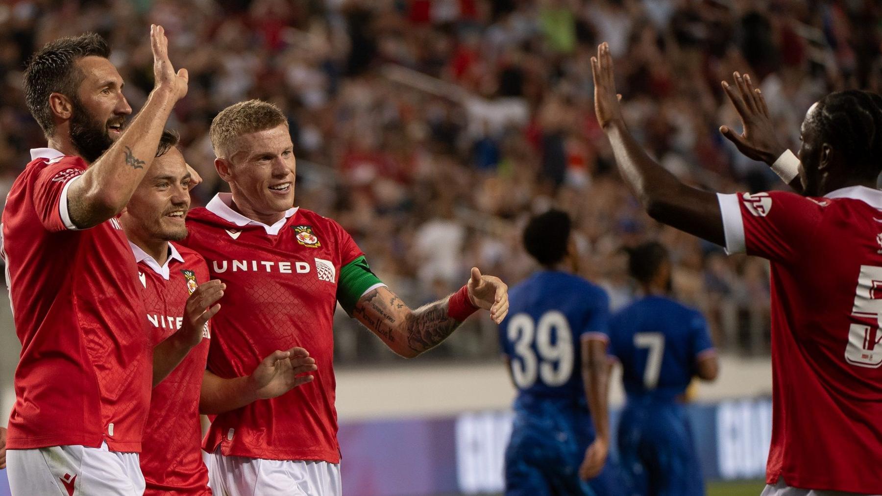 Ollie Palmer (L) leads the Wrexham goal celebrations against Chelsea