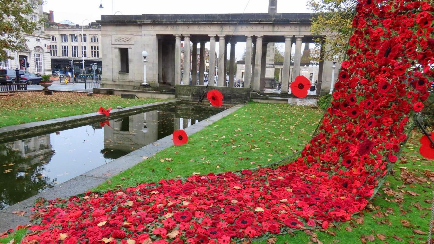 A cascade of knitted poppies in Southport