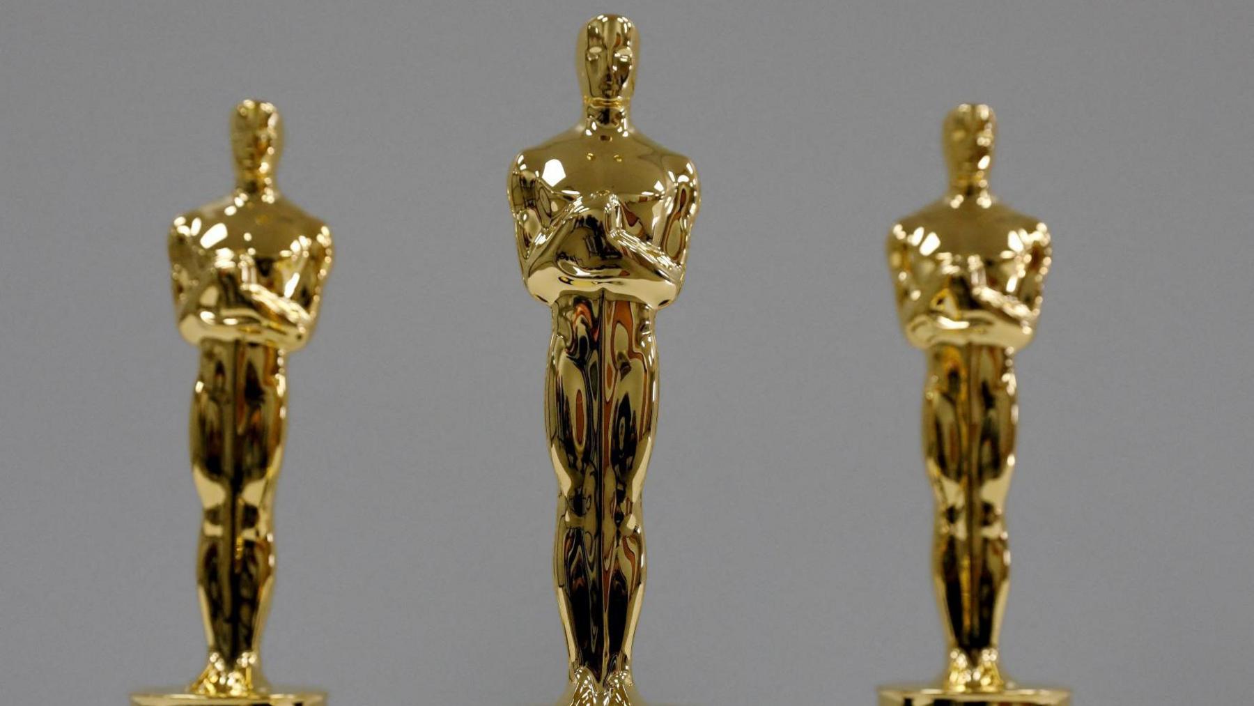 Three gold Oscar statues 