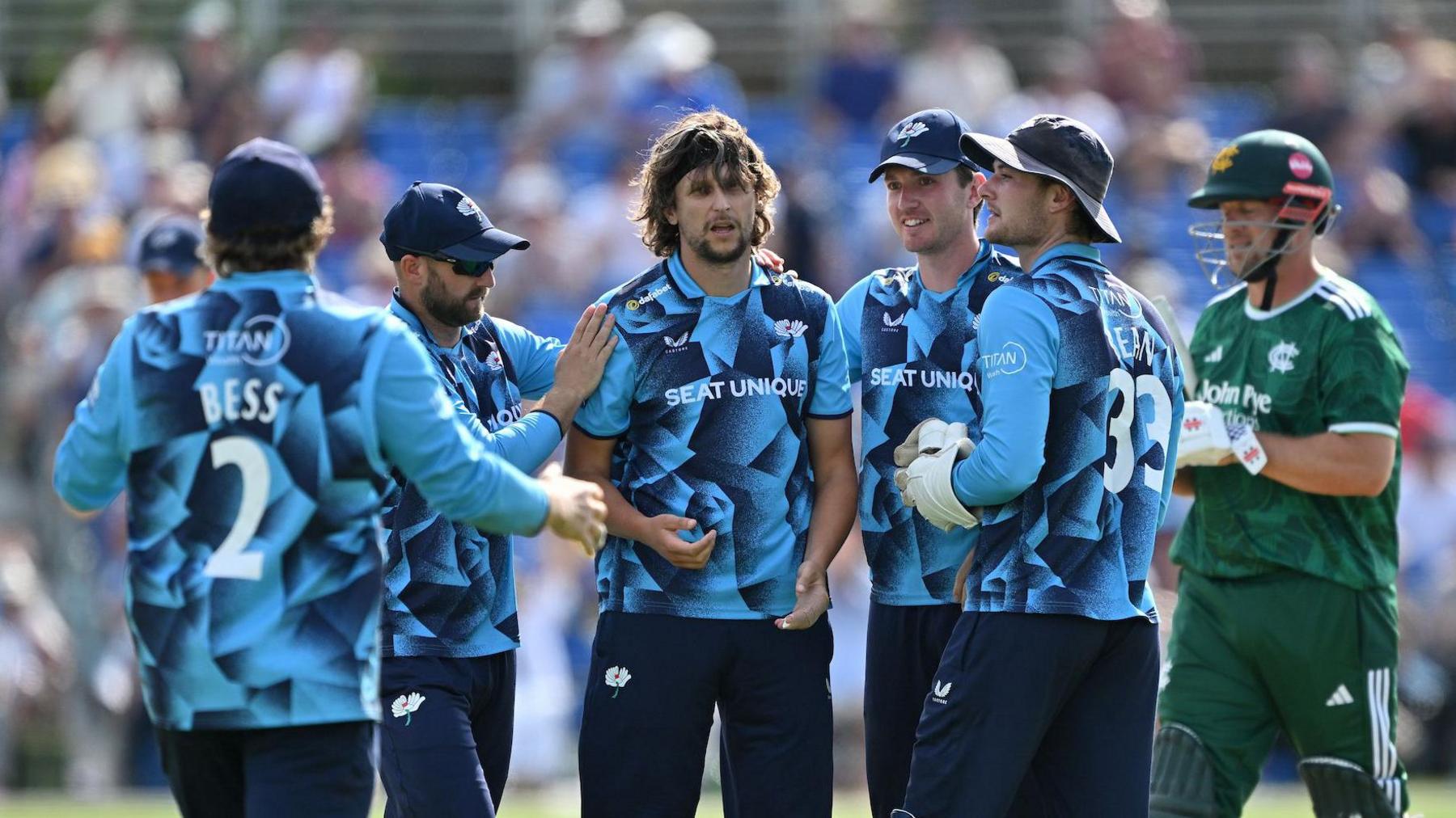 Yorkshire's players surround Jack White as they celebrate taking the wicket of Nottinghamshire's George Munsey at Clifton Park, York