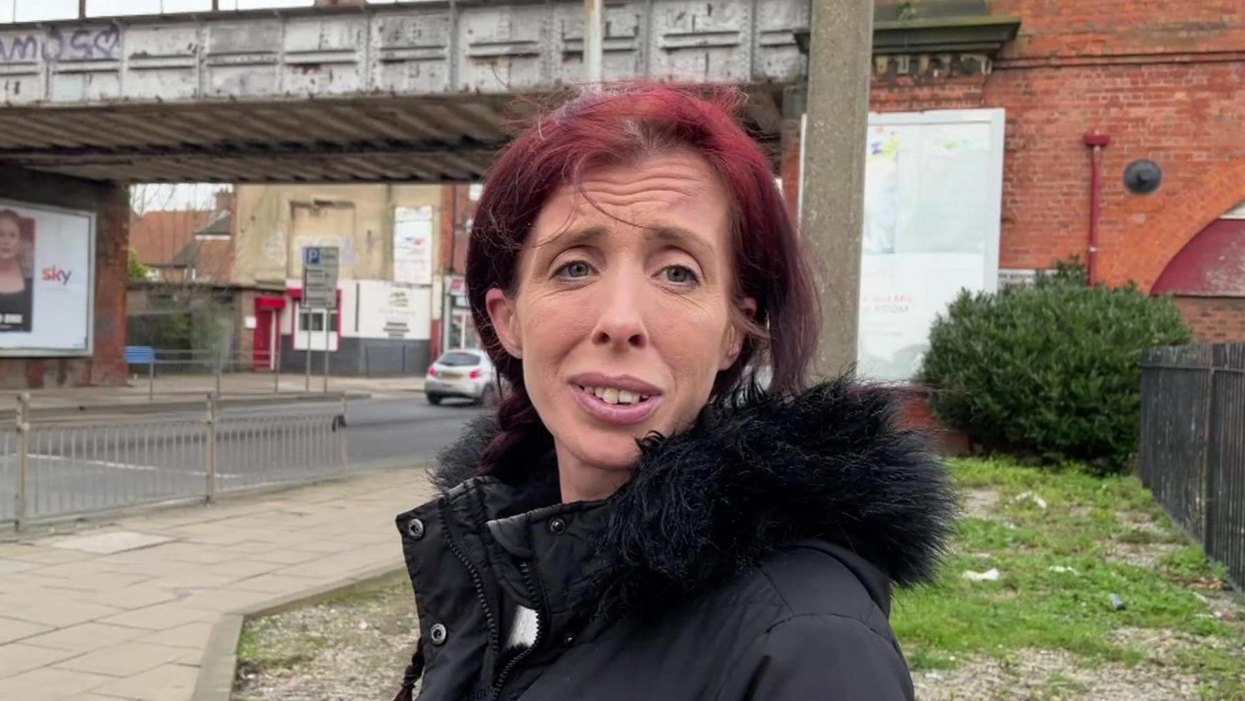 Sarah Sharpe stands in front of the railway bridge on Holderness Road where her cat was thrown from.