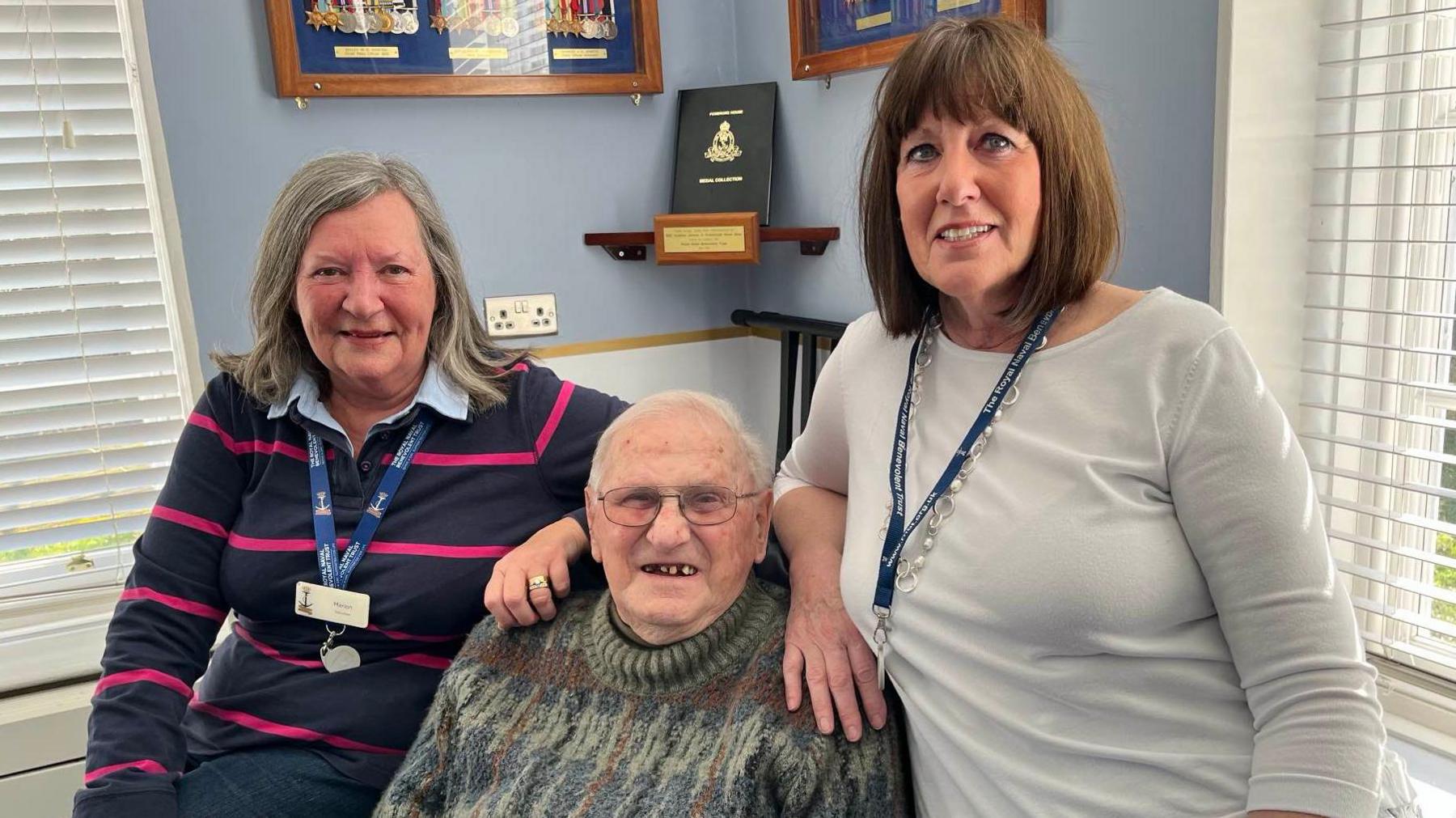 Retired Group Captain Keith Reyner and volunteers Marion Cruse and Kim Buttenshaw sit in lounge at the Royal Navy Benevolent Trust's Pembroke House care home in Gillingham