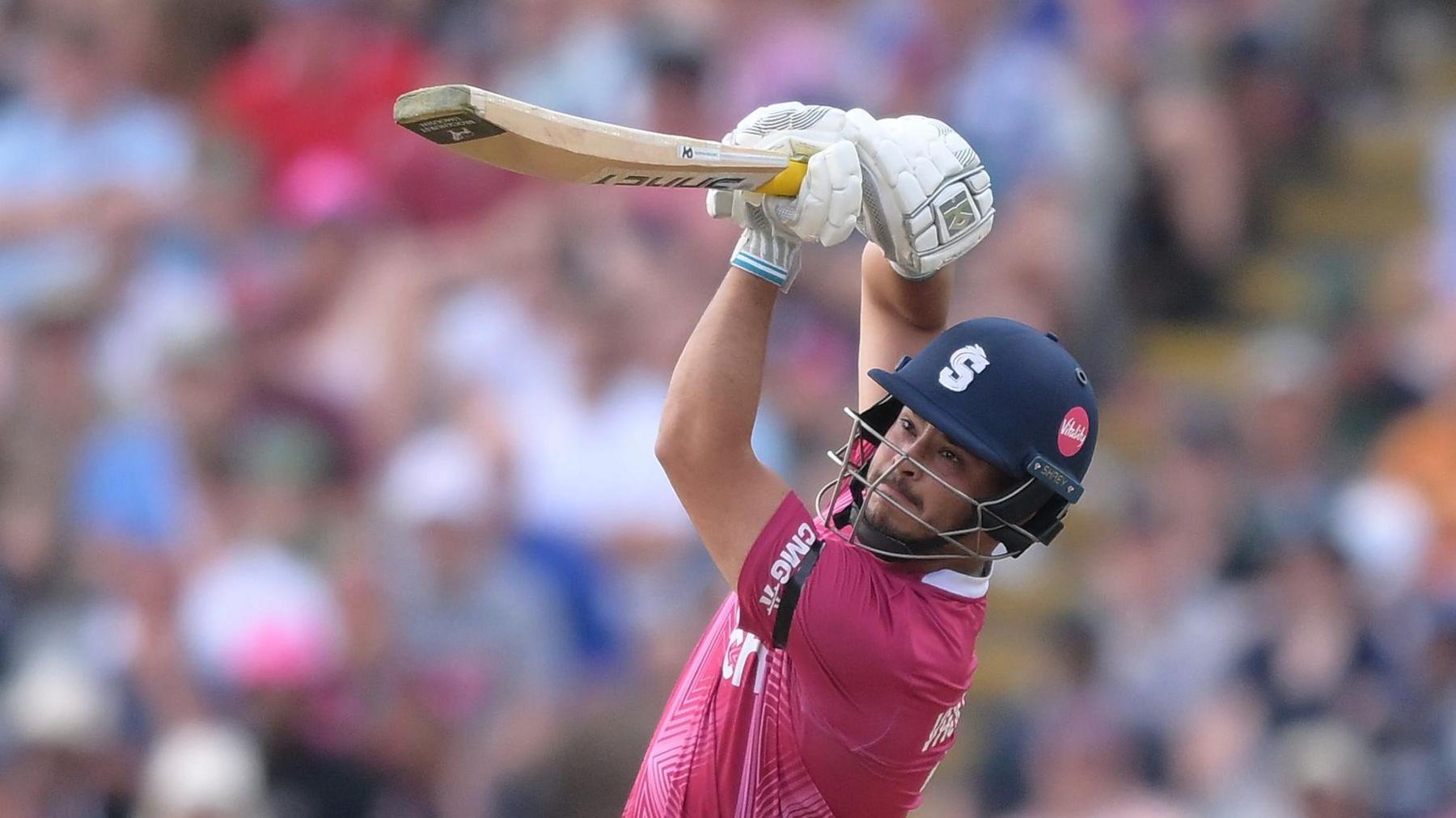 Nathan McSweeney lofts the ball away during an innings for Northamptonshire