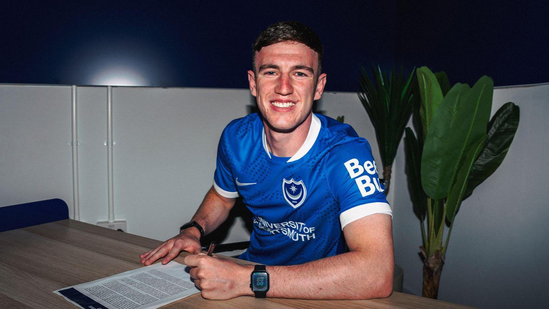 Makenzie Kirk poses for a photo after signing for Portsmouth