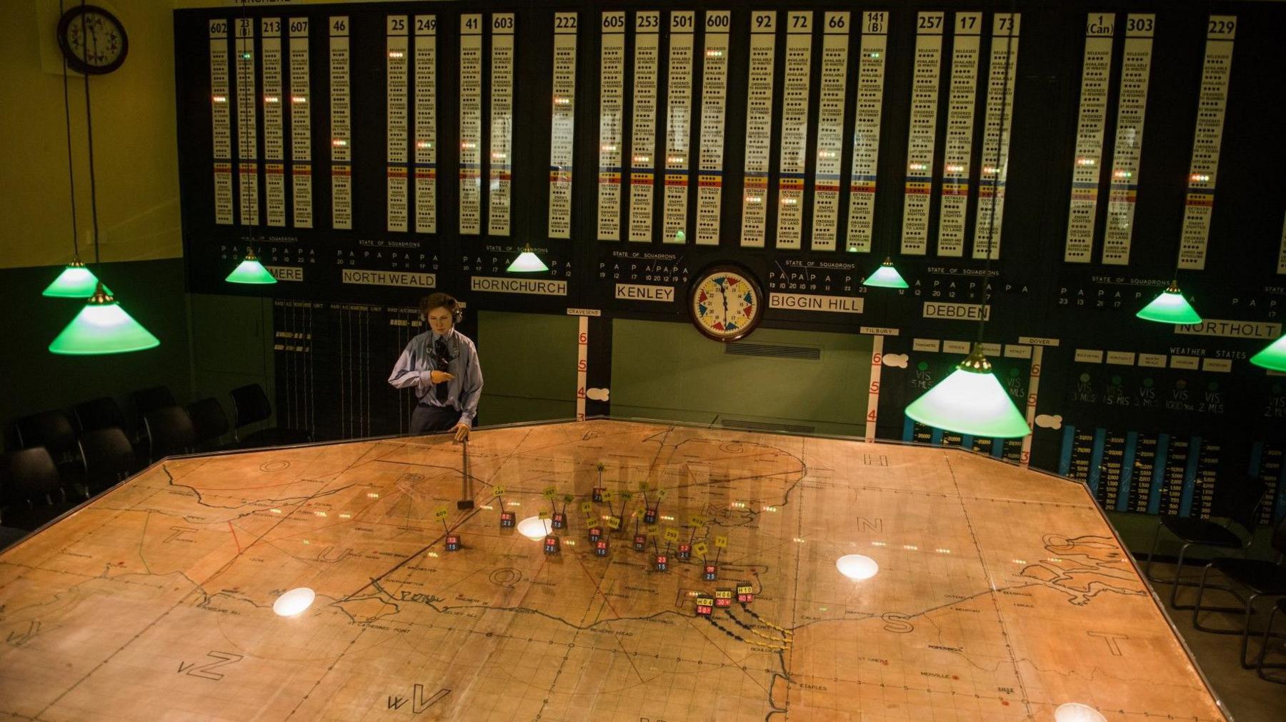 A replica of the WWII operations room inside the Battle of Britain bunker, featuring a detailed map table and a mannequin in uniform simulating the co-ordination of aircraft movements.