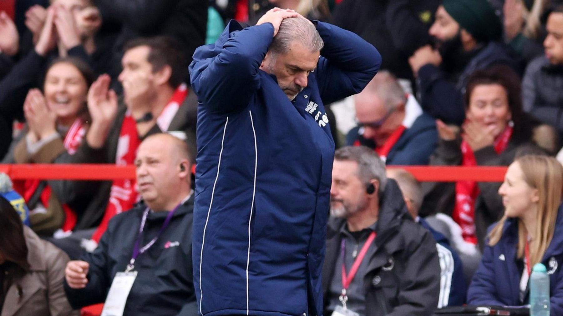 Ange Postecoglou holds his head