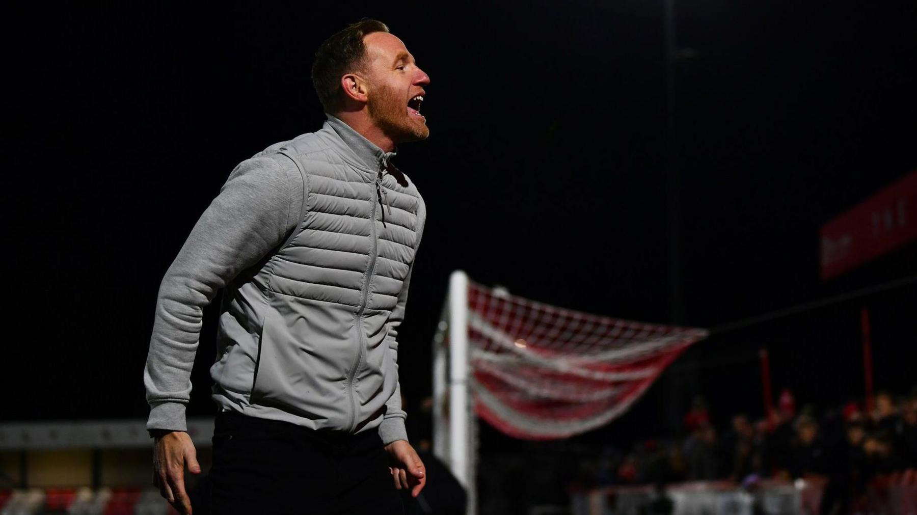 Gavin Cowan celebrates with Brackley's supporters following their win over Notts County