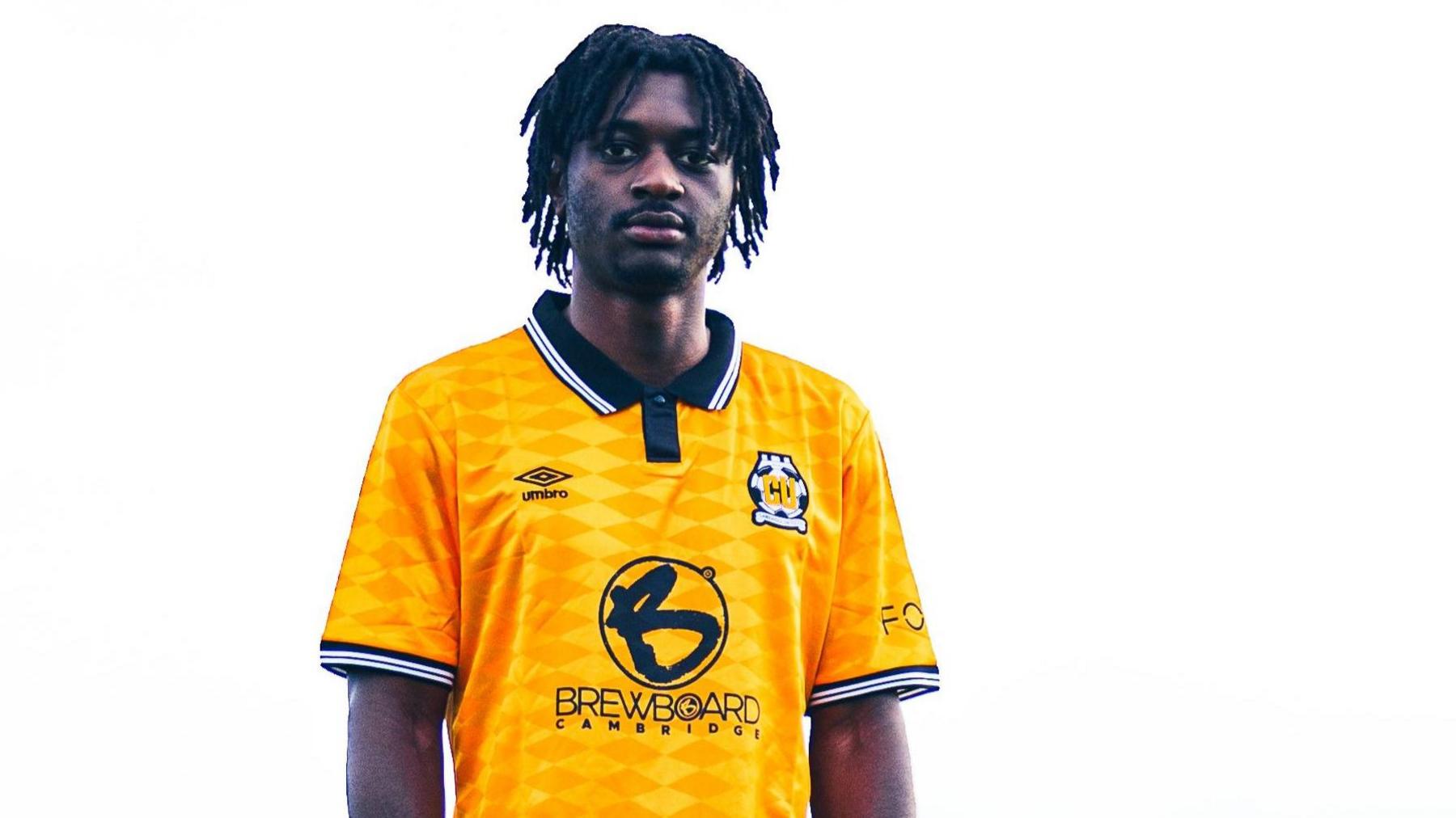 Esapa Osong wearing a Cambridge United shirt