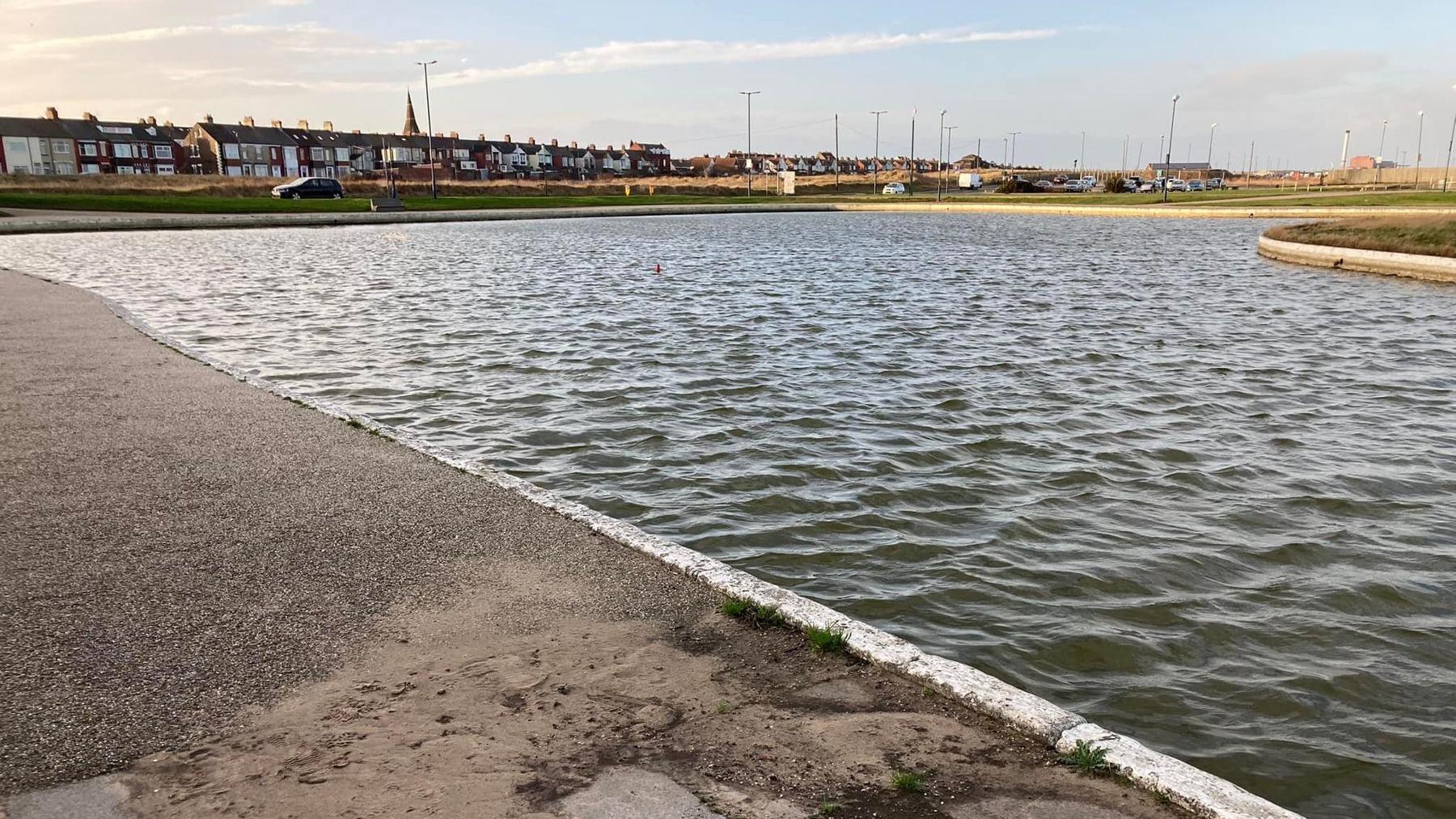 The boating lake in Redcar with houses in the background