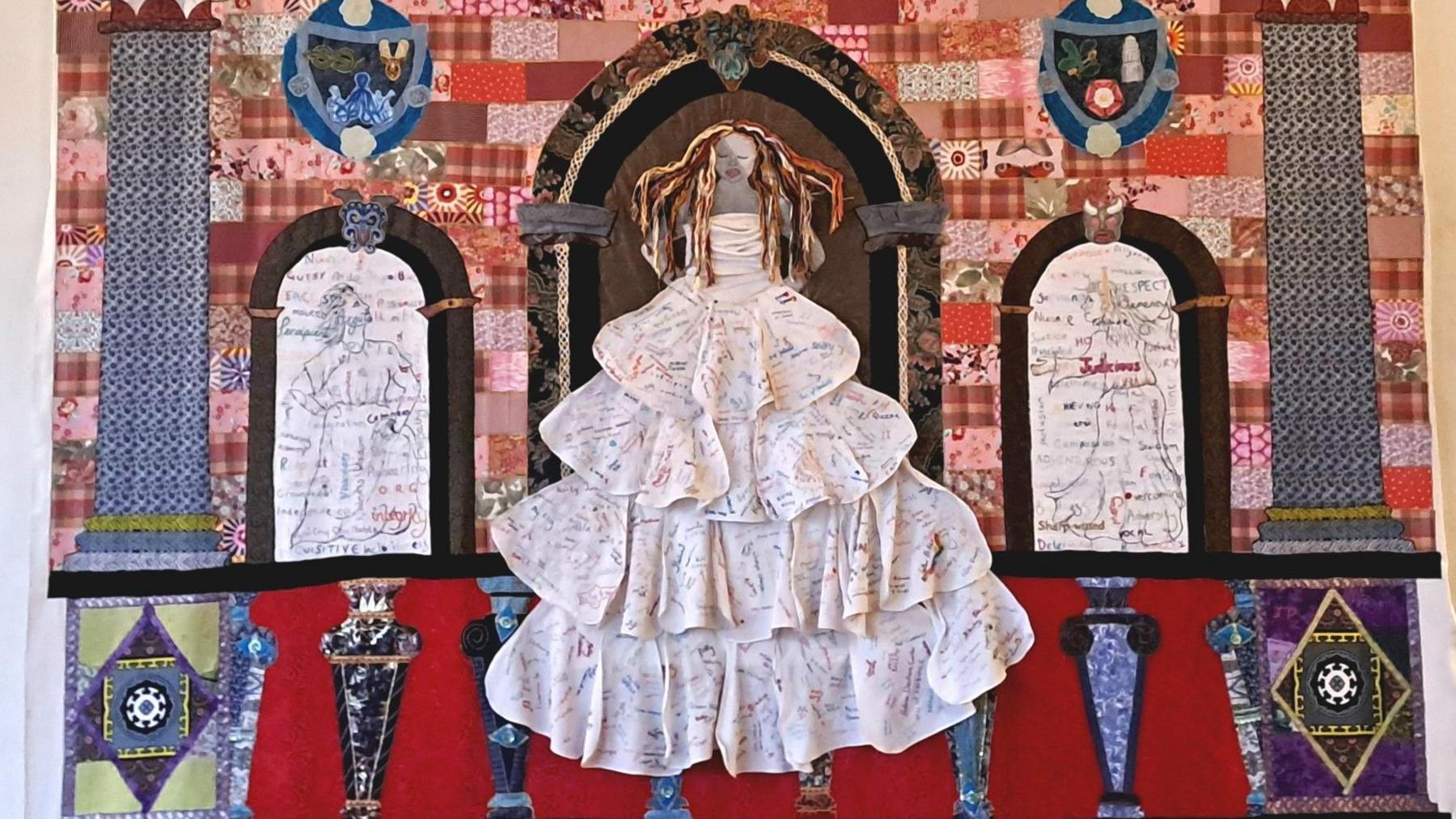 A colourful embroided woman, placed on a large sheet of fabric inside Hardwick Hall in Derbyshire.