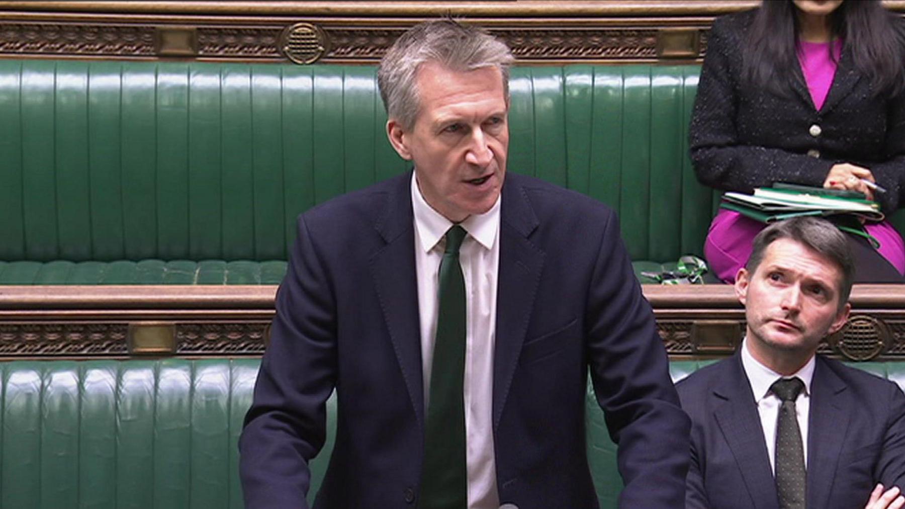Dan Jarvis in the House of Commons, wearing a dark blue suit and green tie