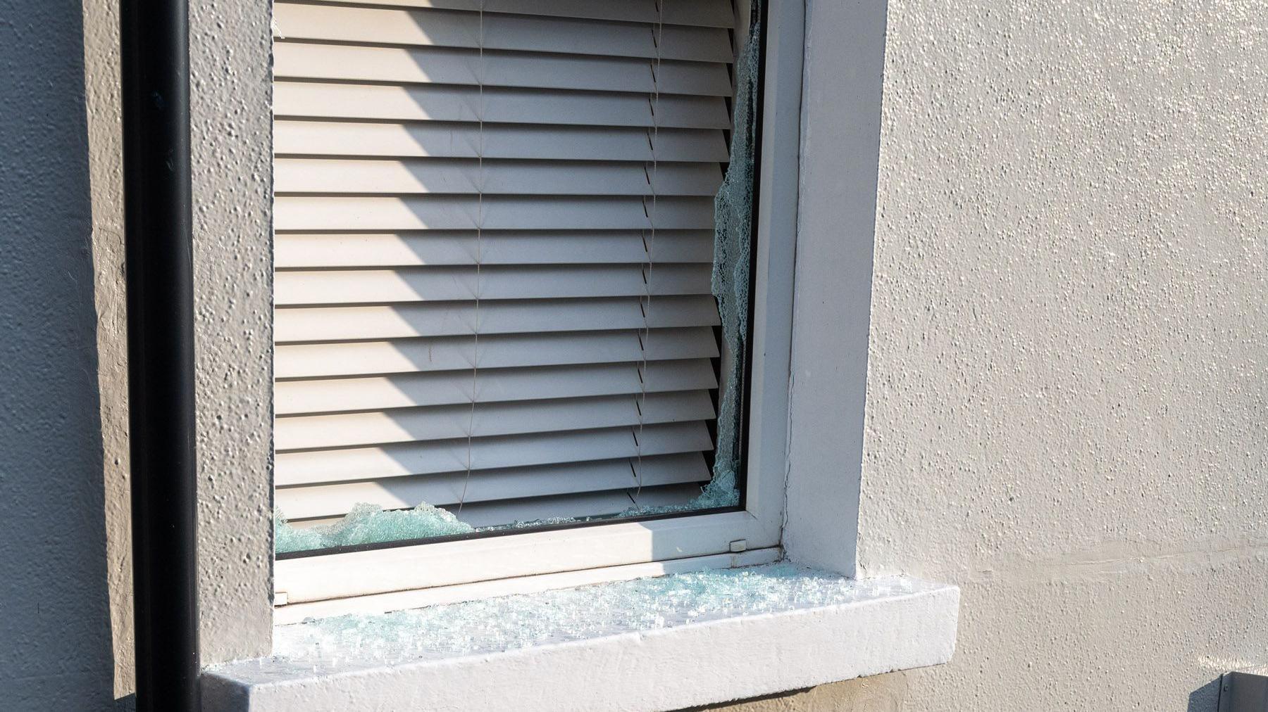 Broken glass on a window sill at a house on Limewood Street in Derry