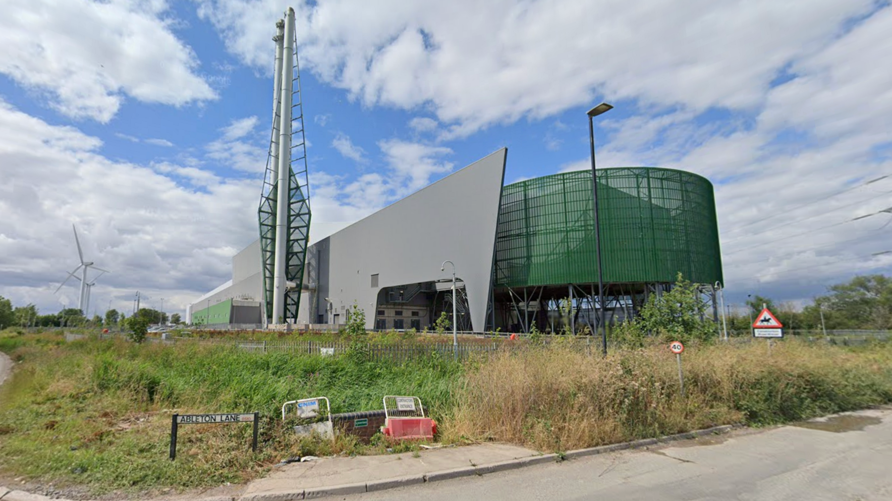 Viridor's recycling plant in Avonmouth. The building is grey and green, with a tall structure at the front. 