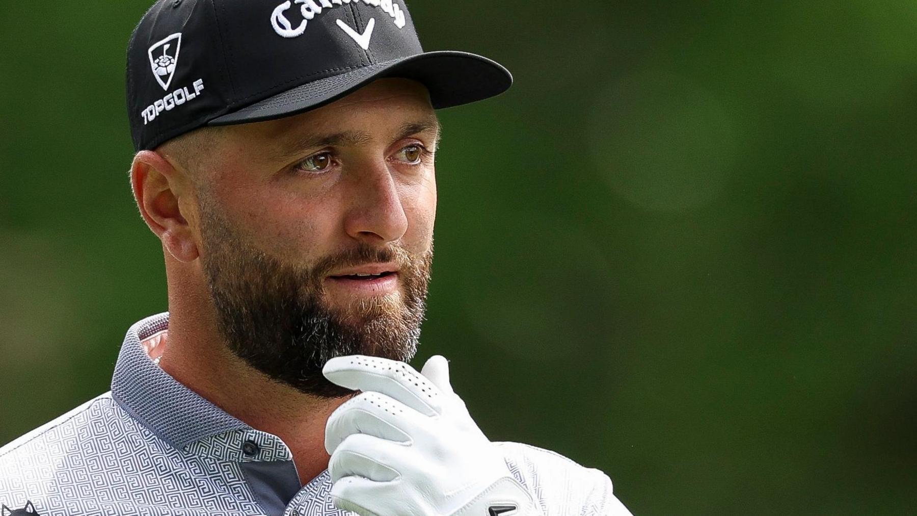 Jon Rahm with his hand on his chin