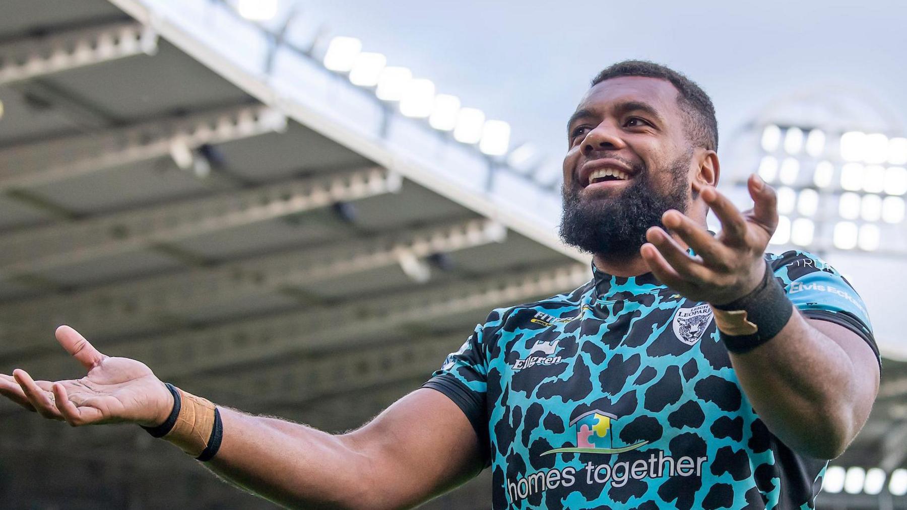 Ben Nakubuwai with his arms out, celebrating after a match towards the Leigh supporters