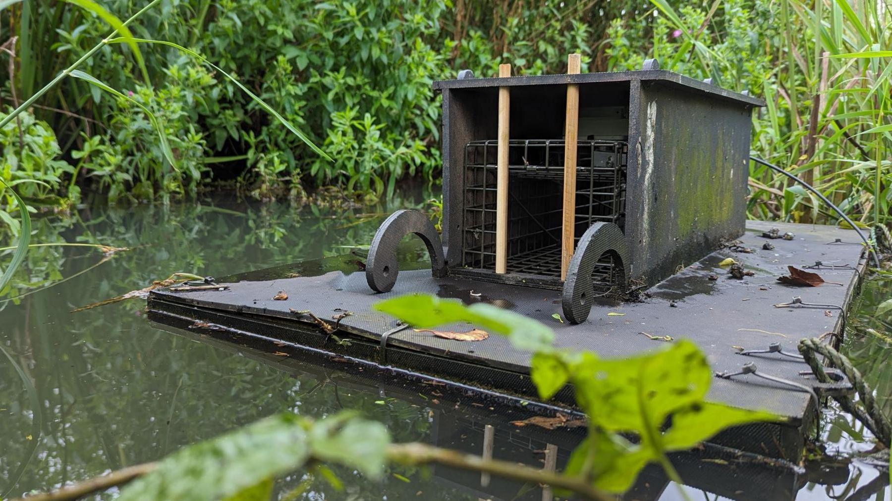 A wooden trap floating on a river