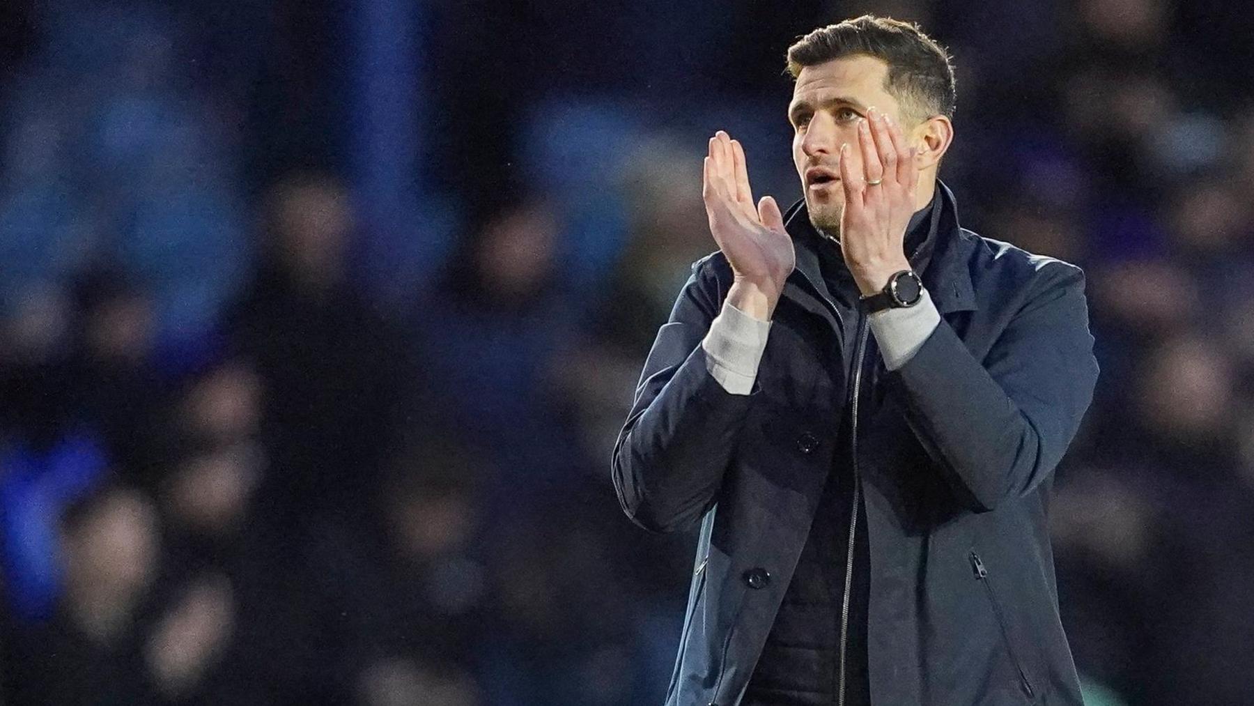 Portsmouth boss John Mousinho applauds the fans after his side's 0-0 draw against Burnley