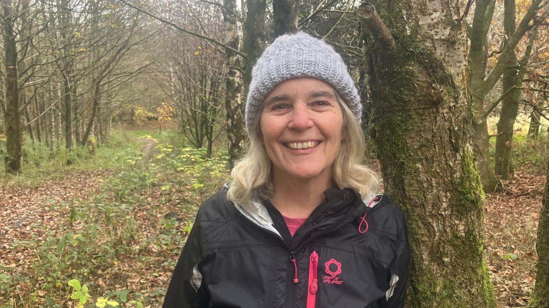 Photo of Dr Jane Wilcock from the Friends of Harwood and Longsight Park in woodland next to where the new homes would've been built.