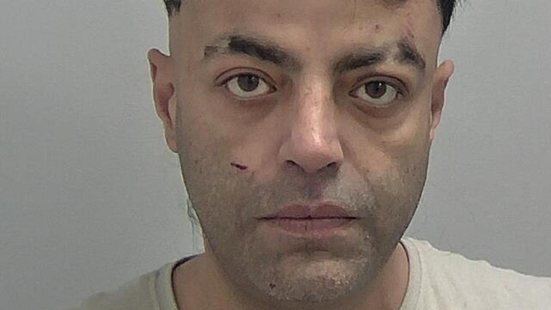 A police mug shot of Choudary