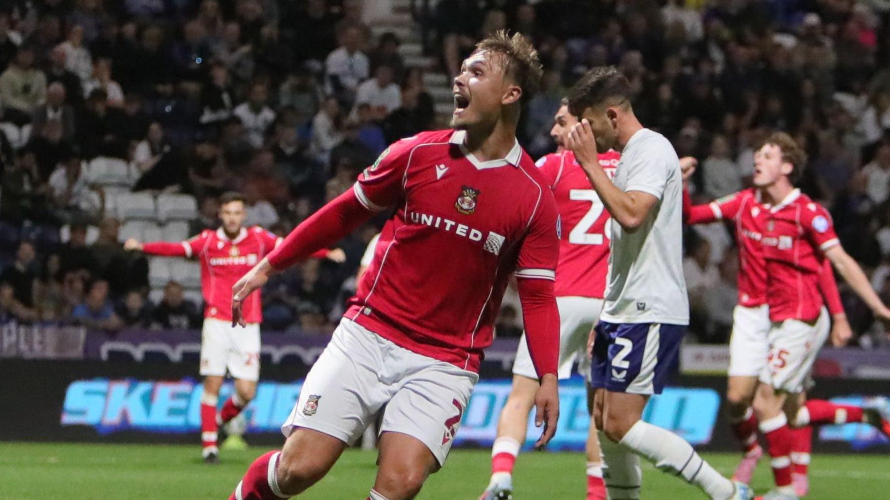 Wrexham's Callum Doyle celebrates team-mate Harry Ashfield's goal