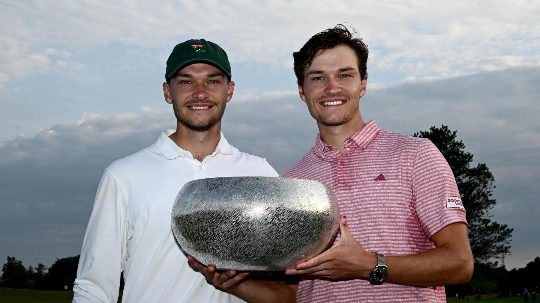 Rasmus Hojgaard (right) poses with his brother Nicolai after winning the 2023  Danish Golf Championship