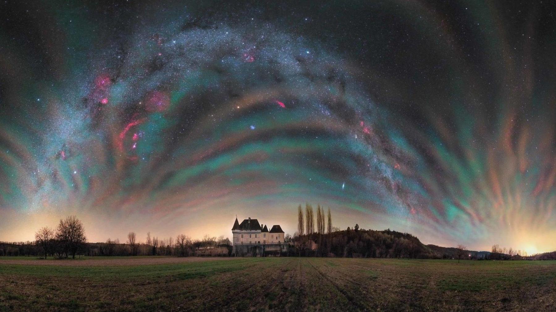 Multicoloured strands of light above a castle in France