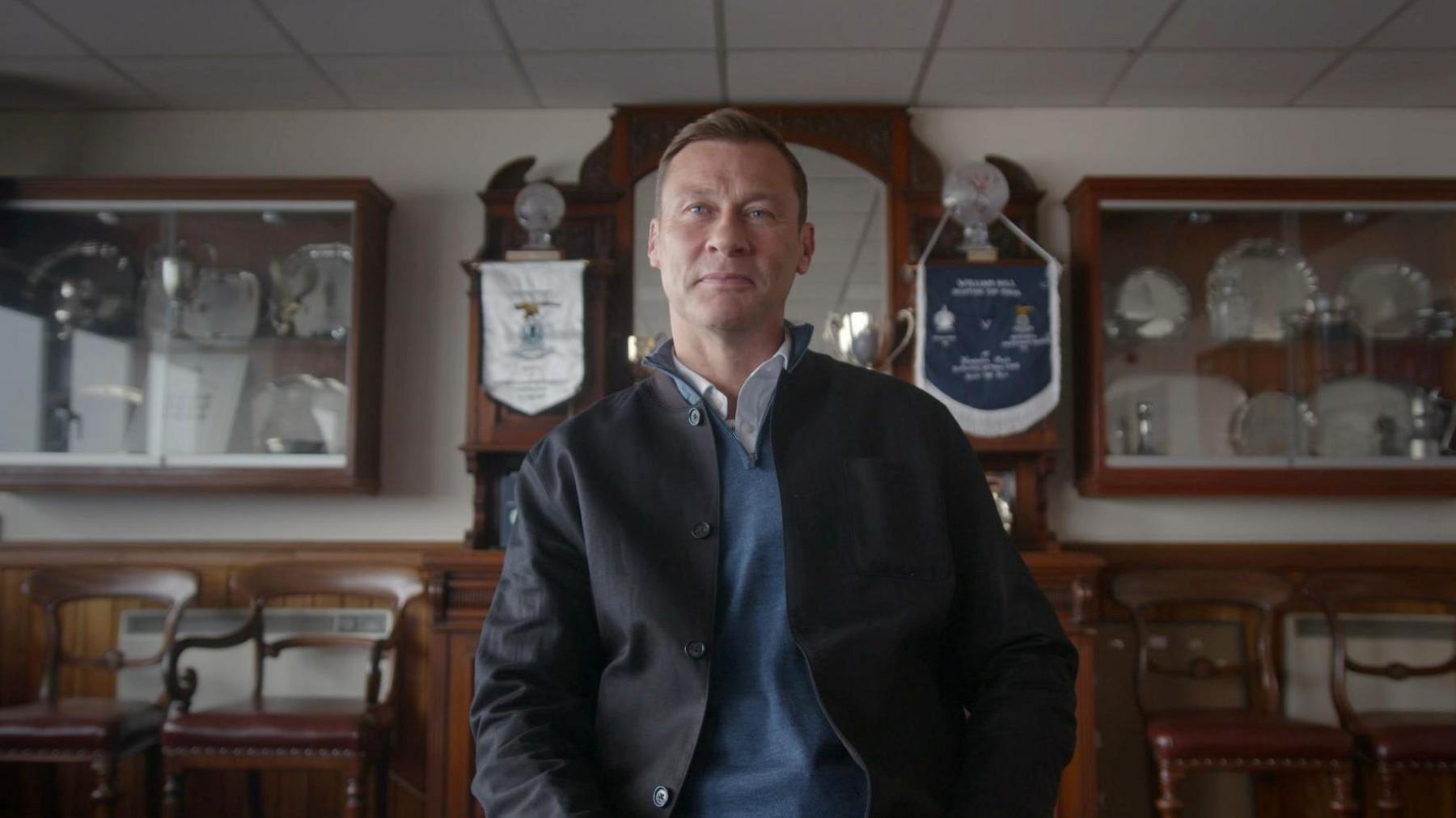 Duncan Ferguson sitting in Inverness CT's trophy room