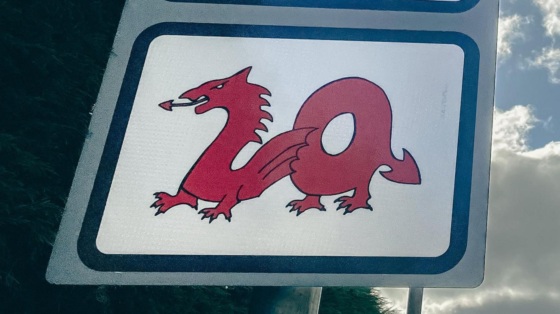 A 20 mph speed limit sign with the 20 Dragon and school warning