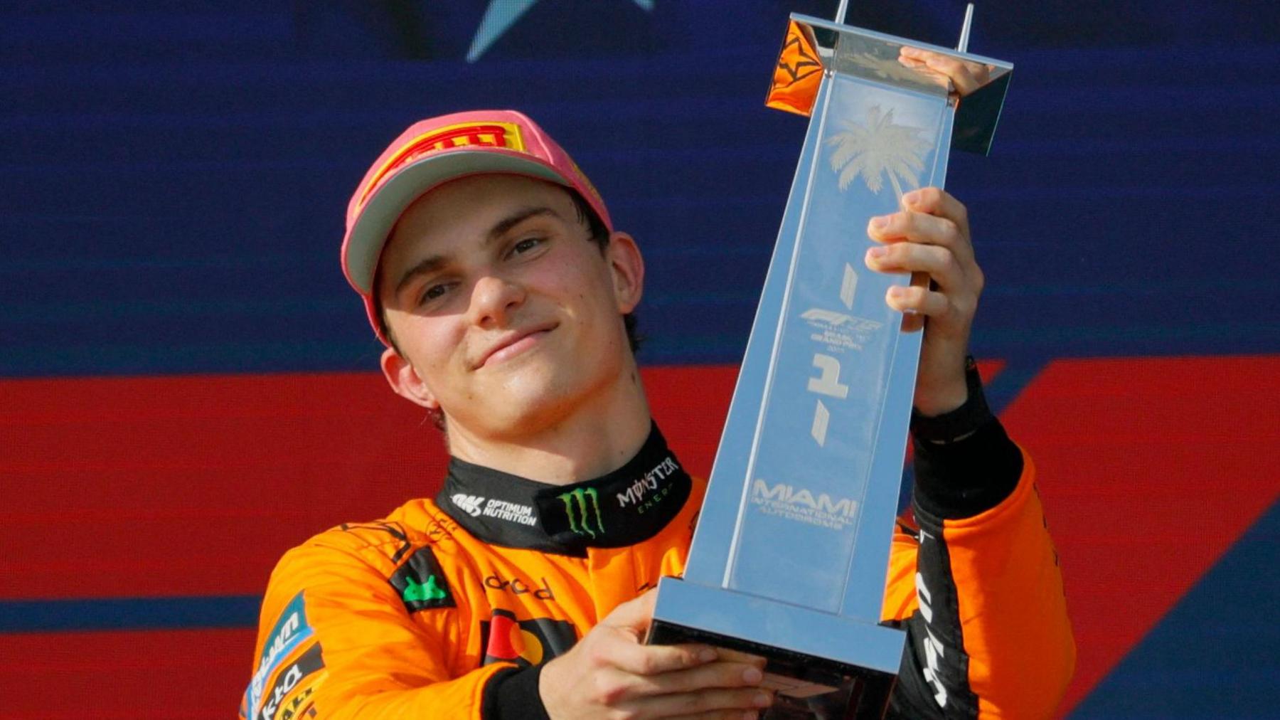 Oscar Piastri lifts the winner's trophy after the Miami Grand Prix