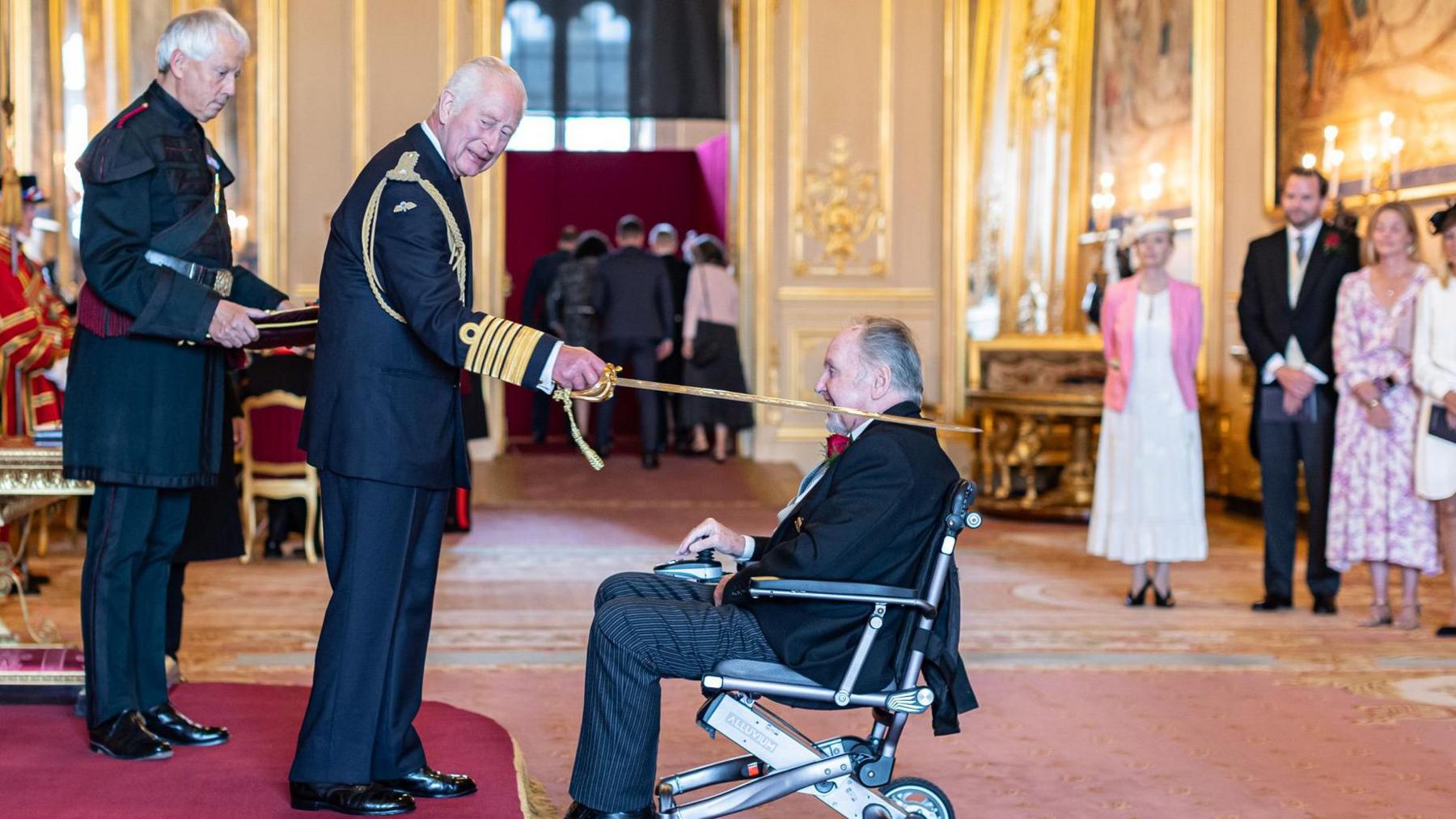 Former Cornish Pirates owner Dicky Evans receives his knighthood from the King 