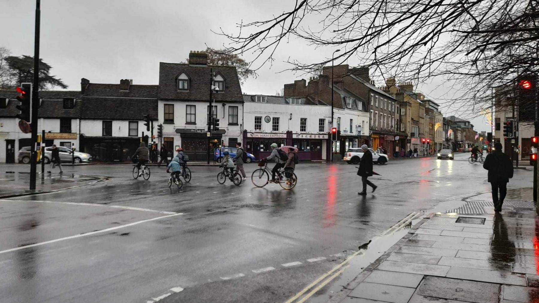 Cyclists cross the road at the Catholic church crossroads in Cambridge