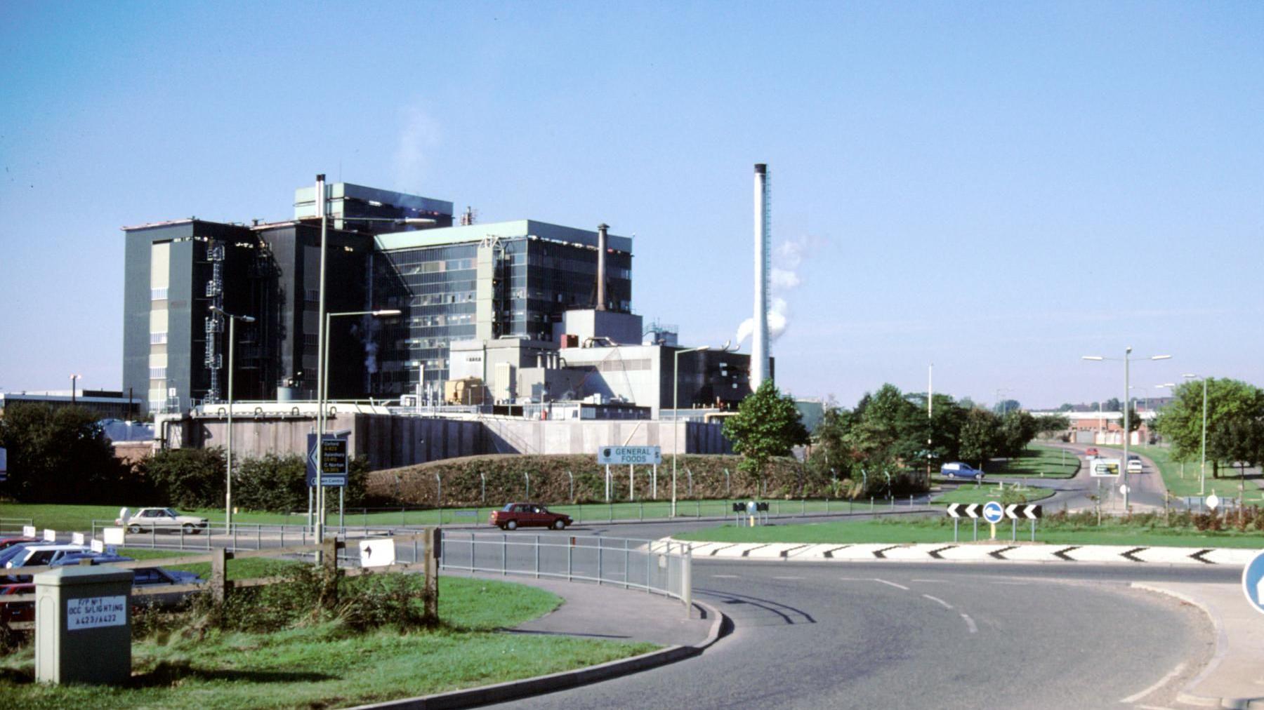 An image from 1988 of the green plant rising above a near roundabout.
