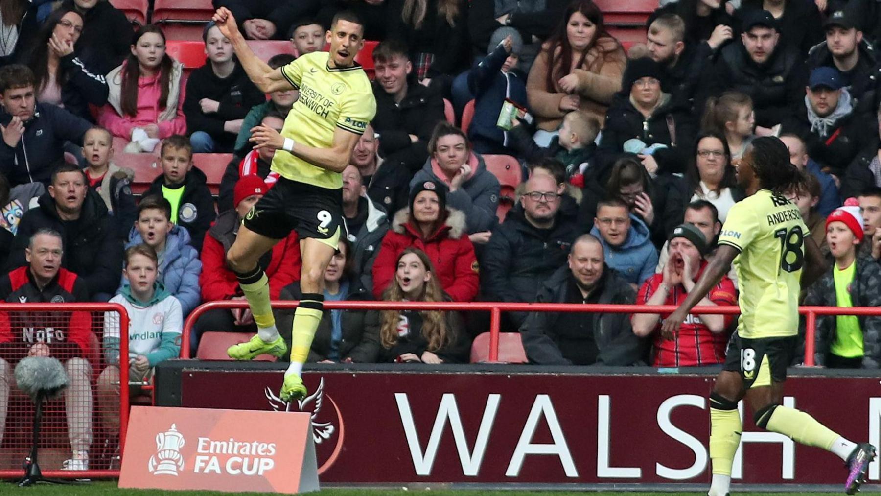 Gassan Ahadme leaps into the air after opening the scoring for Charlton