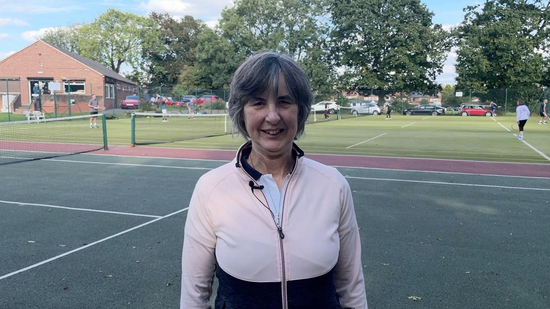 Karen Standen standing on the tennis court