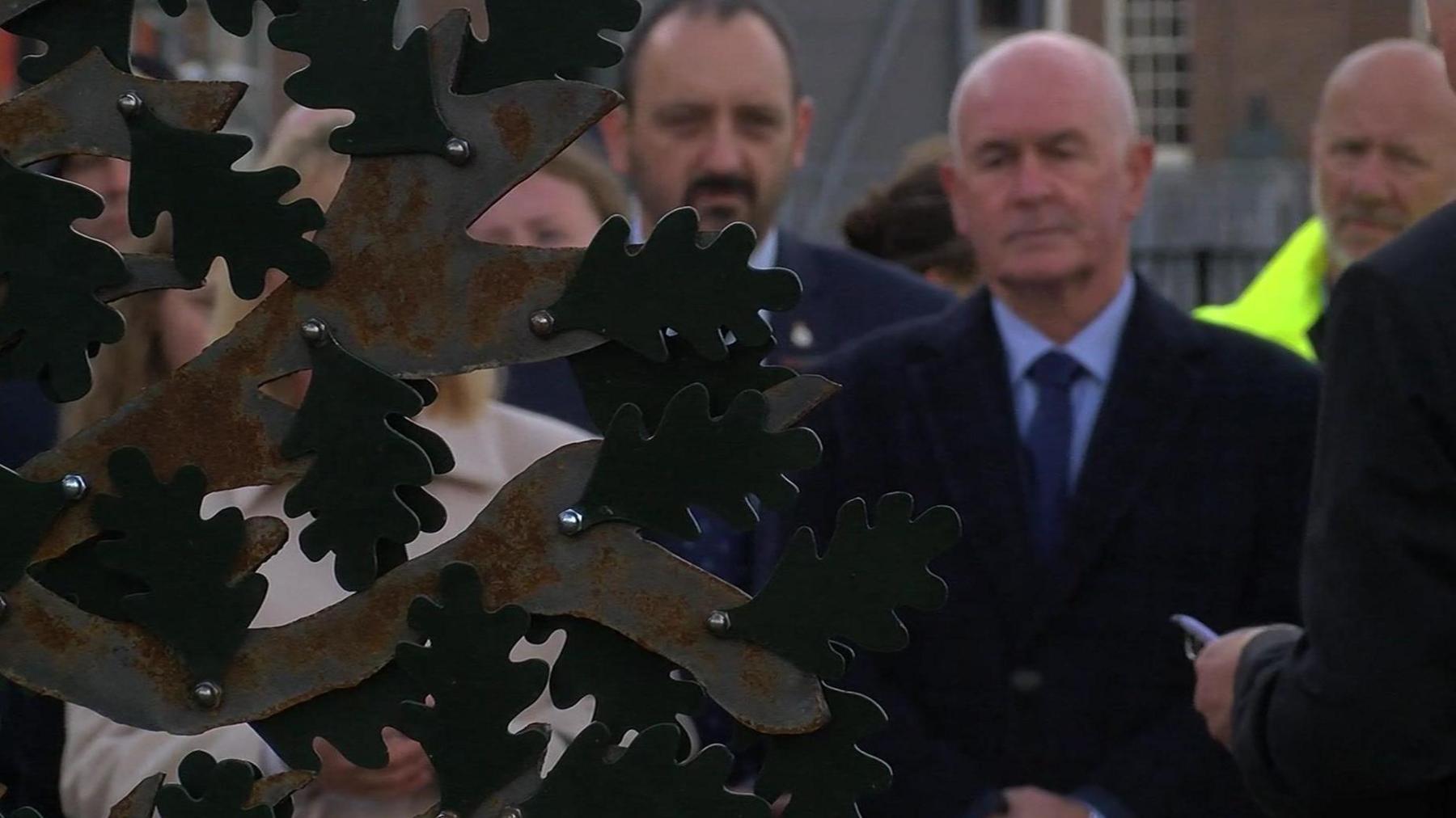 Another close up, looking through the tree and seeing the crowd gathered beyond.