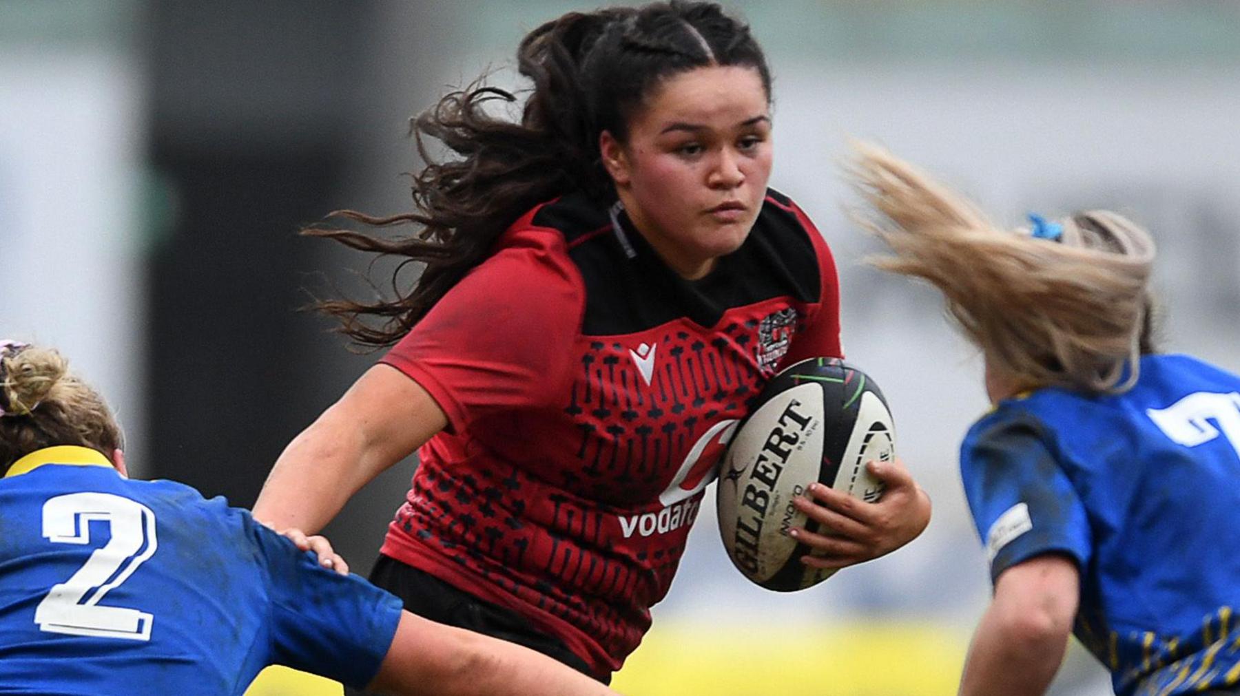 Jorja Aiono of Brython Thunder is challenged by Molly Reardon and Anwen Owen of Gwalia Lightning